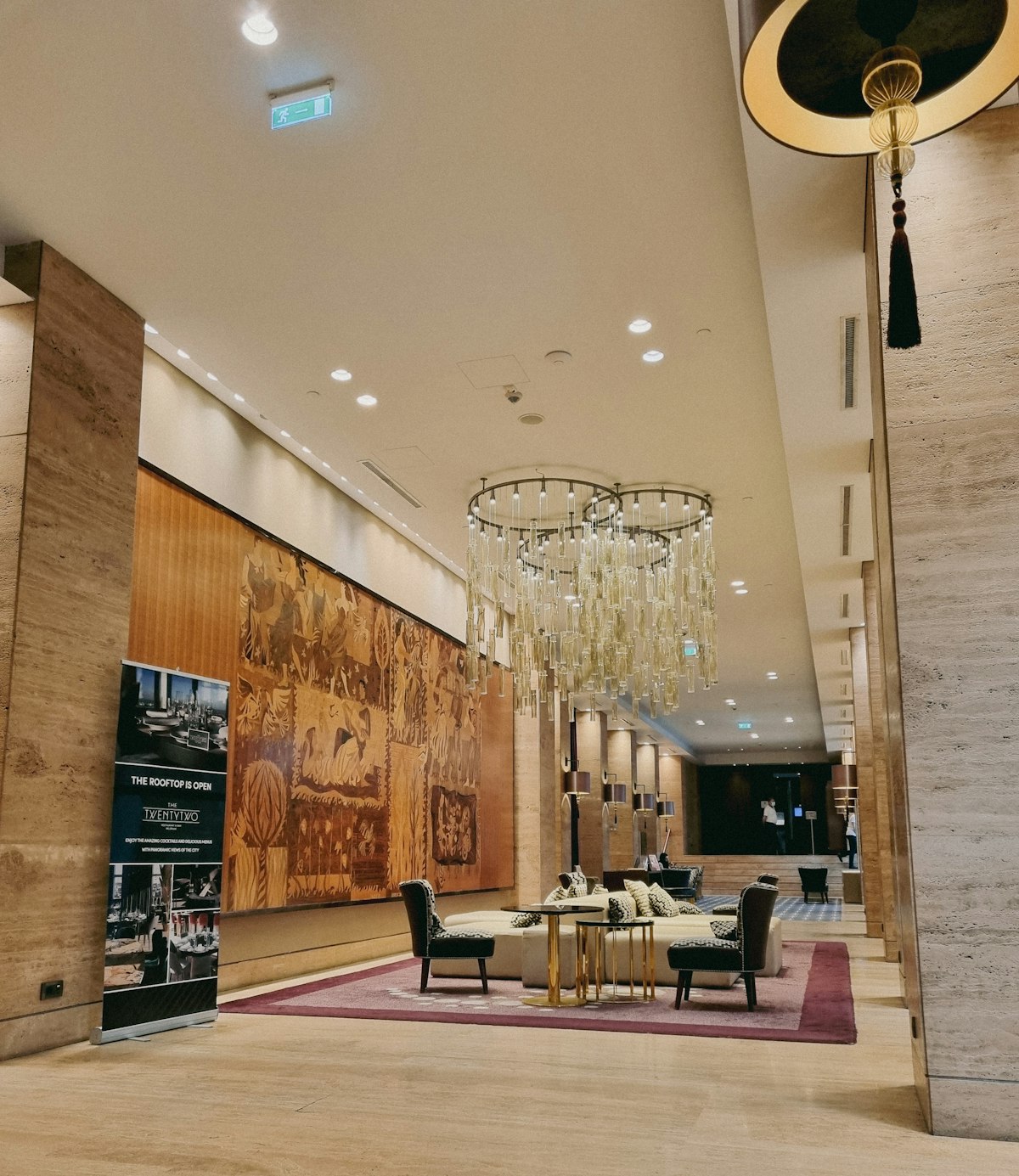 Hotel lobby with comfortable seating and a chandelier